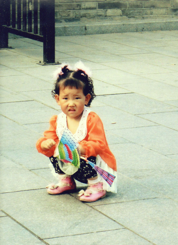 Girl-squatting in bright clothing in Shaanxi Province China