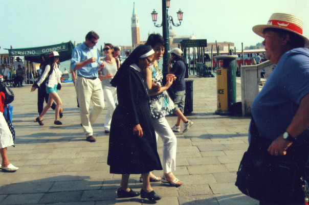 Women talking while walking though buy street