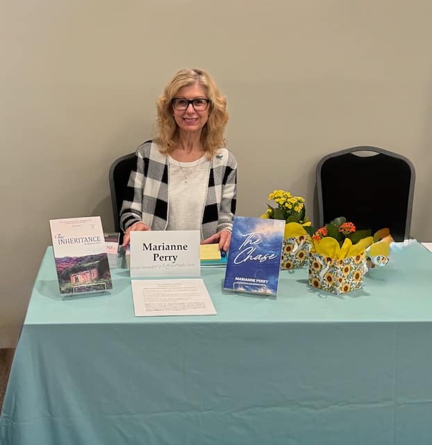 Marianne sittingat her table for the event.